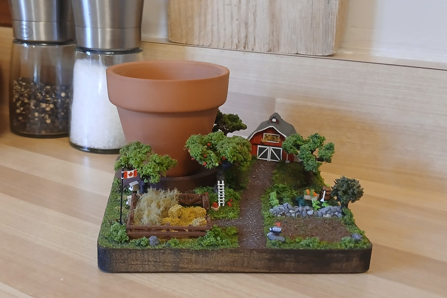 Miniature model farm scene with barn, trees, garden, field and pathways on a wooden plaque Pot holder, model display, candle holder, diorama