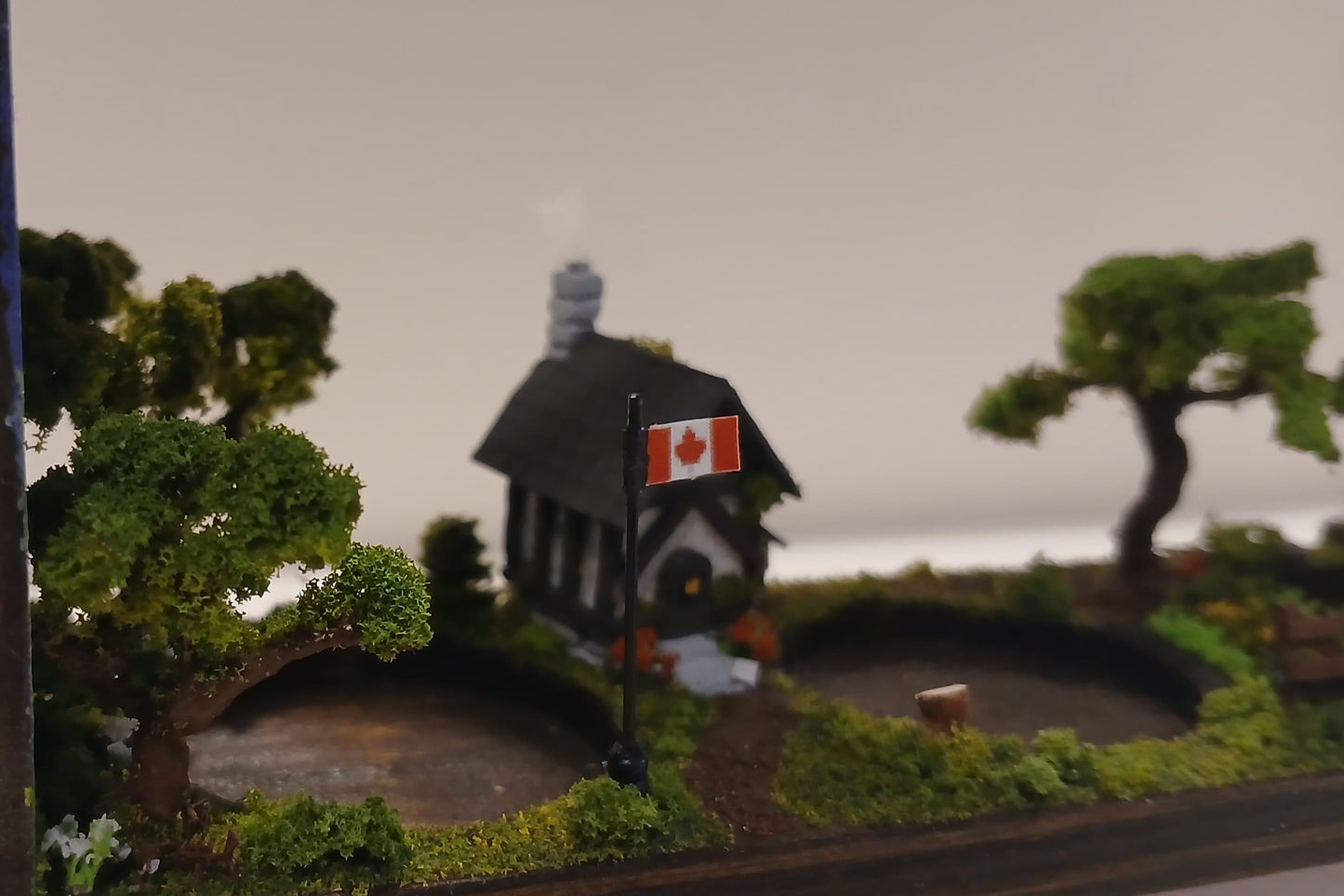 Handmade three glass tube wooden base propagation system. Miniature model chalet and garden scene with realistic trees and Canadian flag.