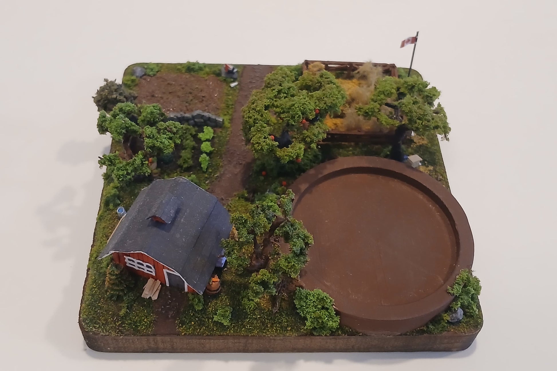 Miniature model farm scene with barn, trees, garden, field and pathways on a wooden plaque Pot holder, model display, candle holder, diorama