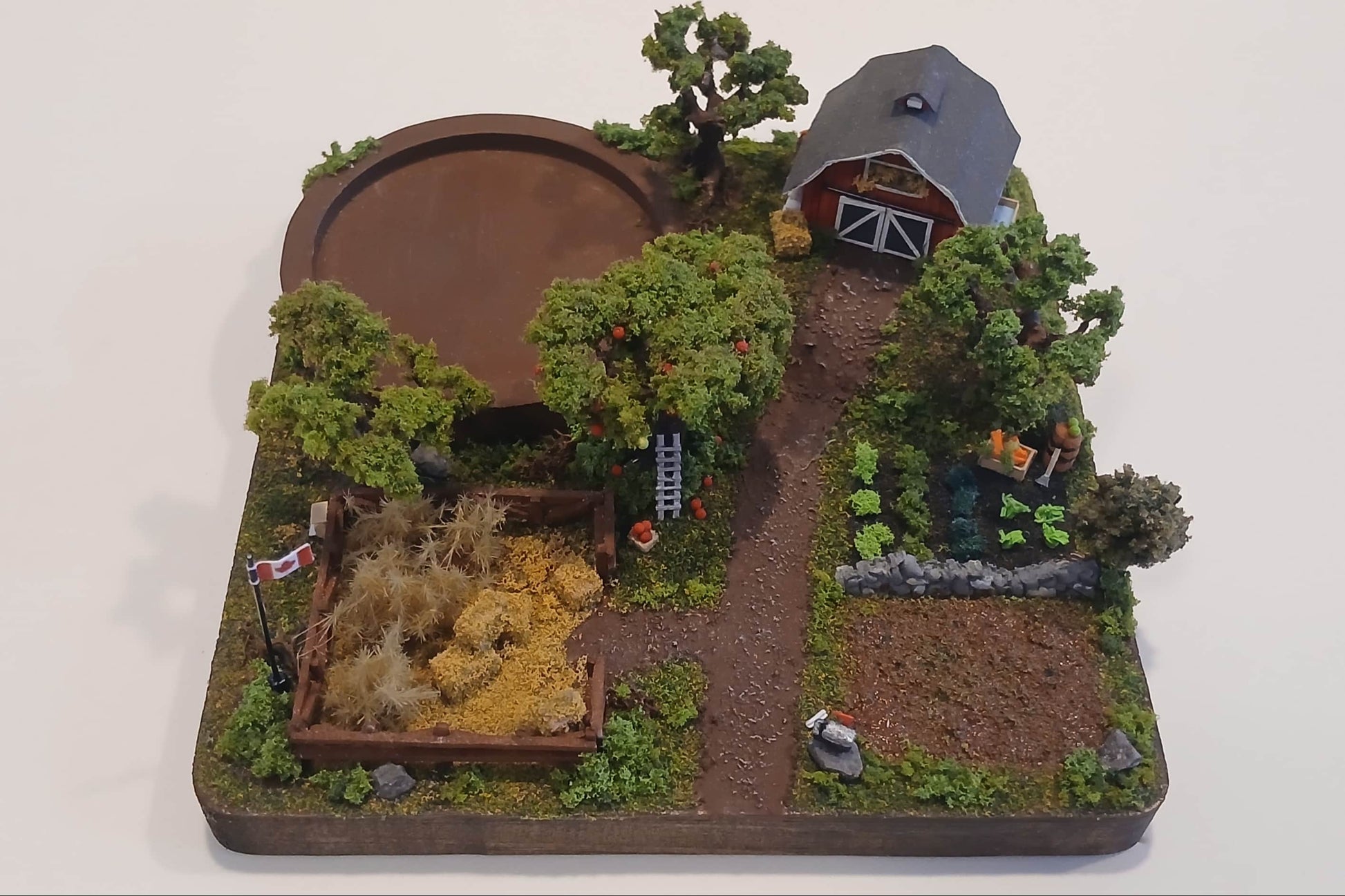 Miniature model farm scene with barn, trees, garden, field and pathways on a wooden plaque Pot holder, model display, candle holder, diorama
