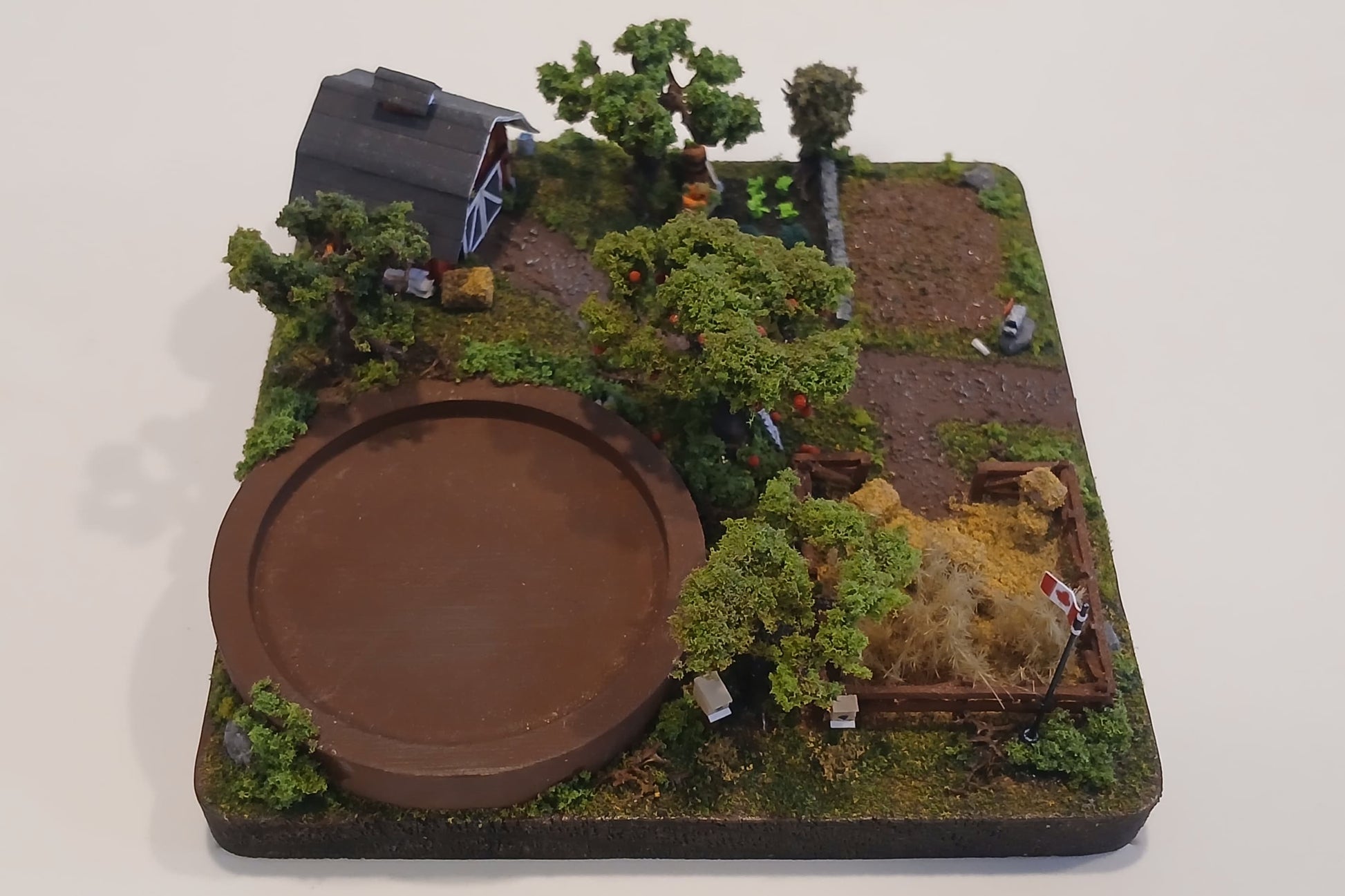 Miniature model farm scene with barn, trees, garden, field and pathways on a wooden plaque Pot holder, model display, candle holder, diorama