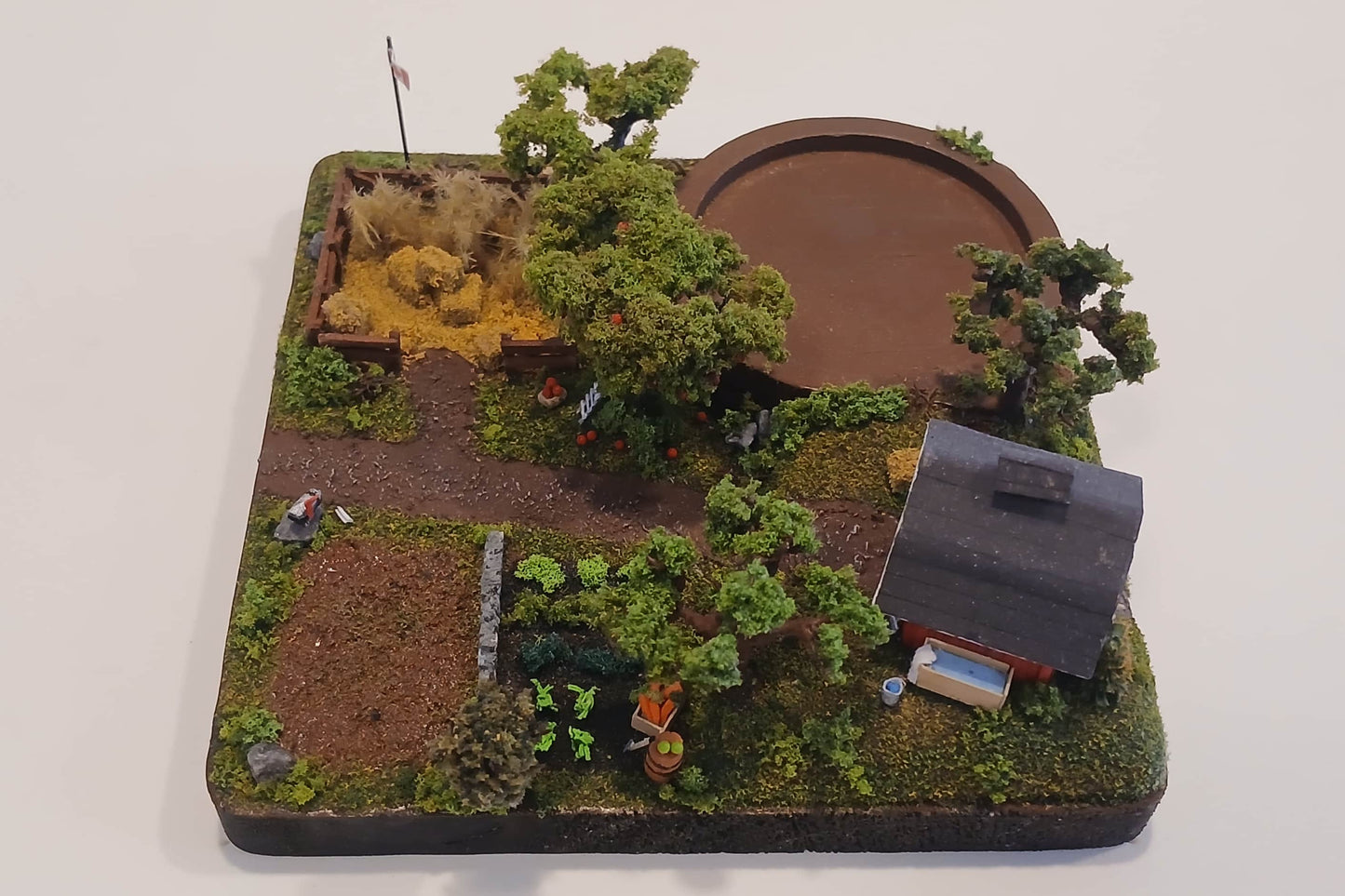 Miniature model farm scene with barn, trees, garden, field and pathways on a wooden plaque Pot holder, model display, candle holder, diorama