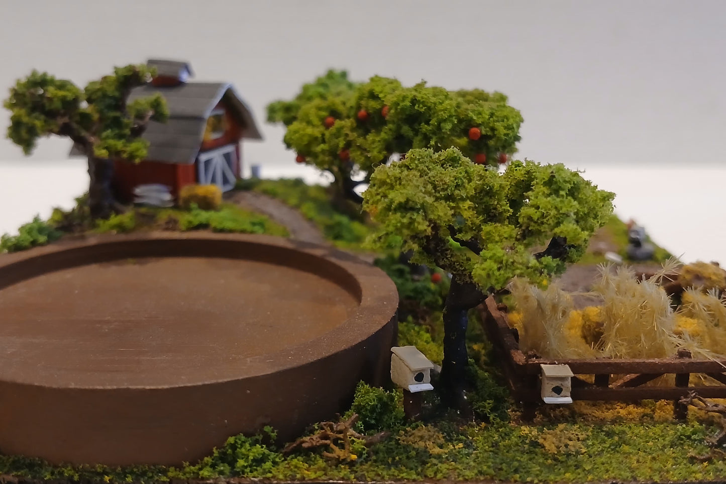 Miniature model farm scene with barn, trees, garden, field and pathways on a wooden plaque Pot holder, model display, candle holder, diorama