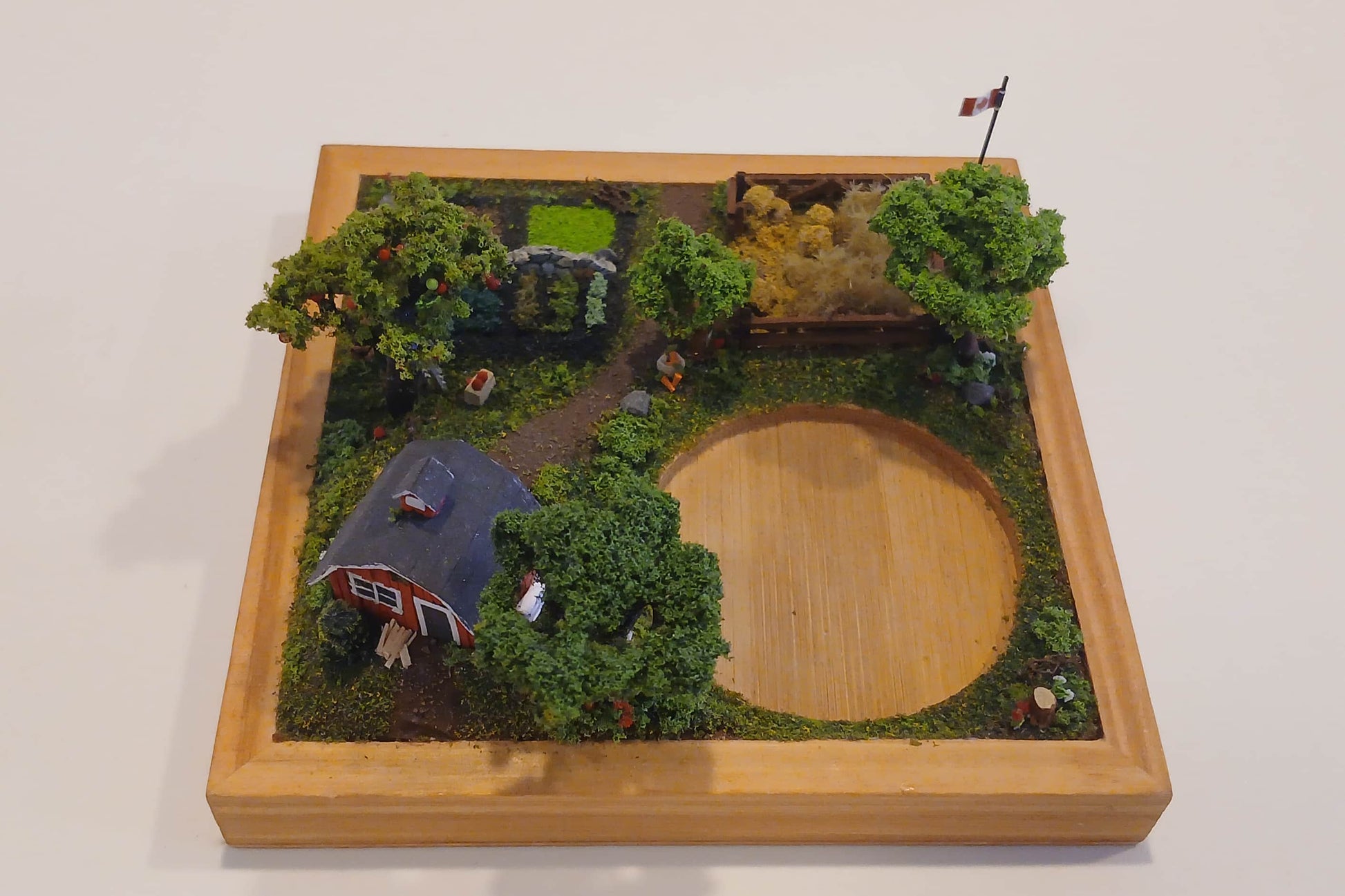 Miniature model farm scene with barn, trees, garden, field and pathways mounted within a wooden base  Pot holder, model display, candle holder, diorama